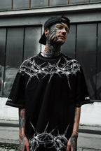 Front view of male model wearing the black Thorn graphic oversized t-shirt men India.