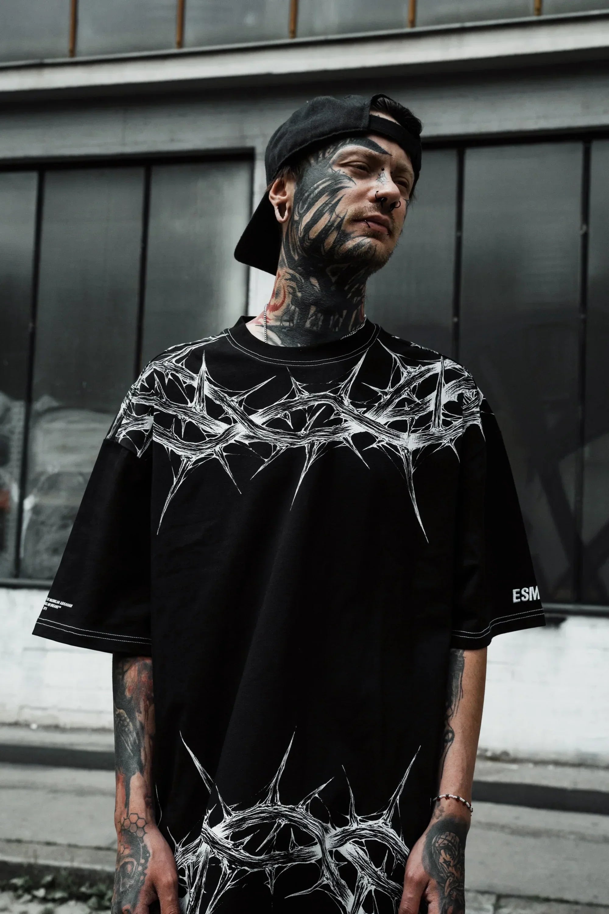 Front view of male model wearing the black Thorn graphic oversized t-shirt men India.