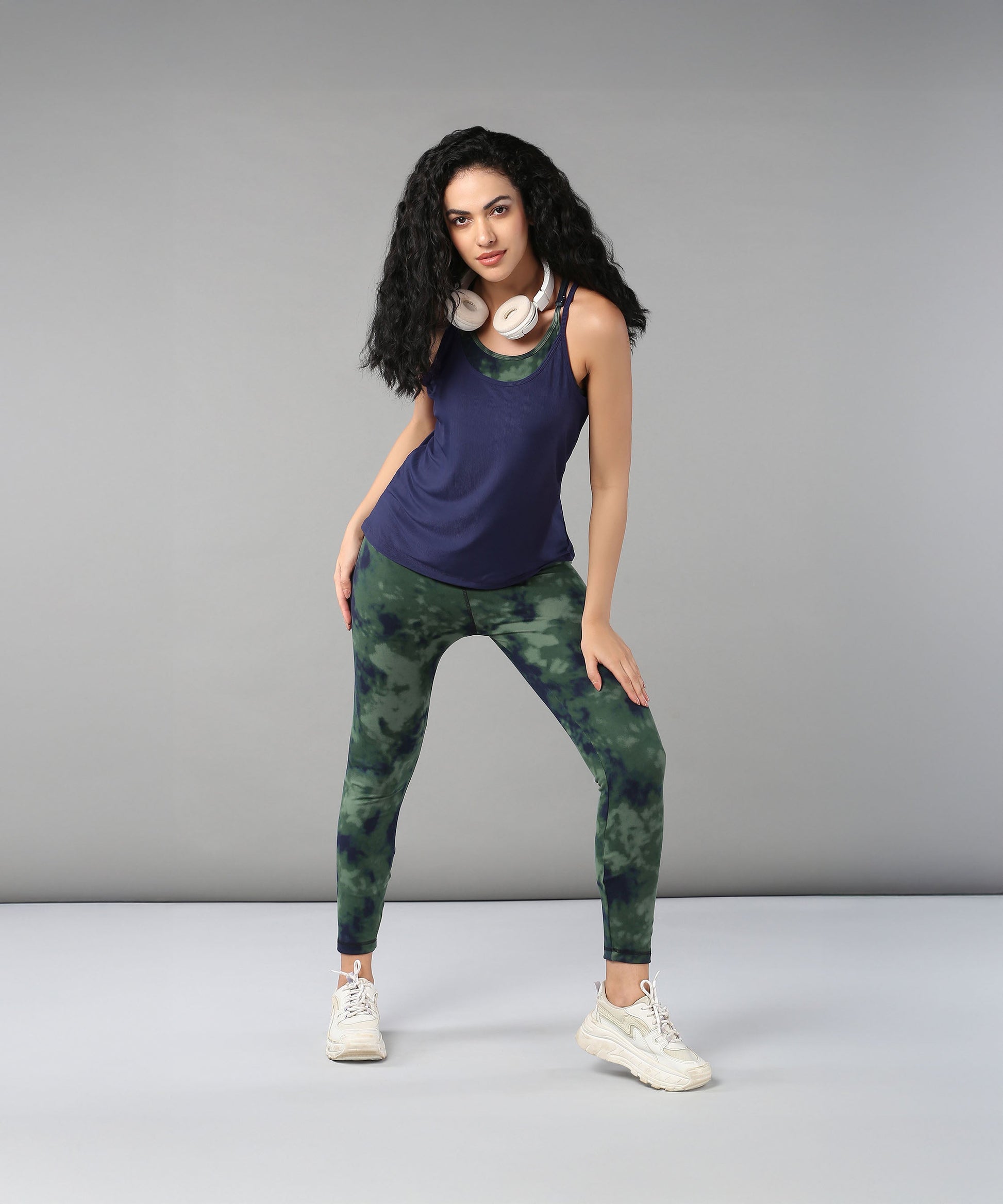 Model wearing a navy top and green tie dye bra t shirt for stylish activewear looks