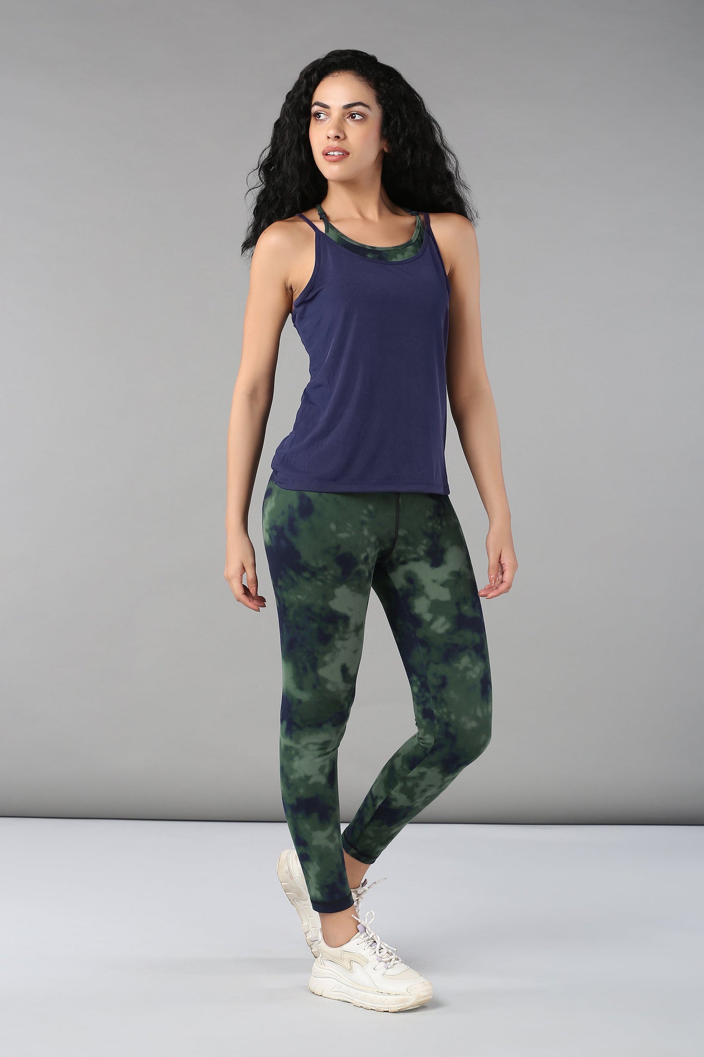 Stylera tie dye bra t shirt paired with green tie dye leggings for a stylish workout outfit