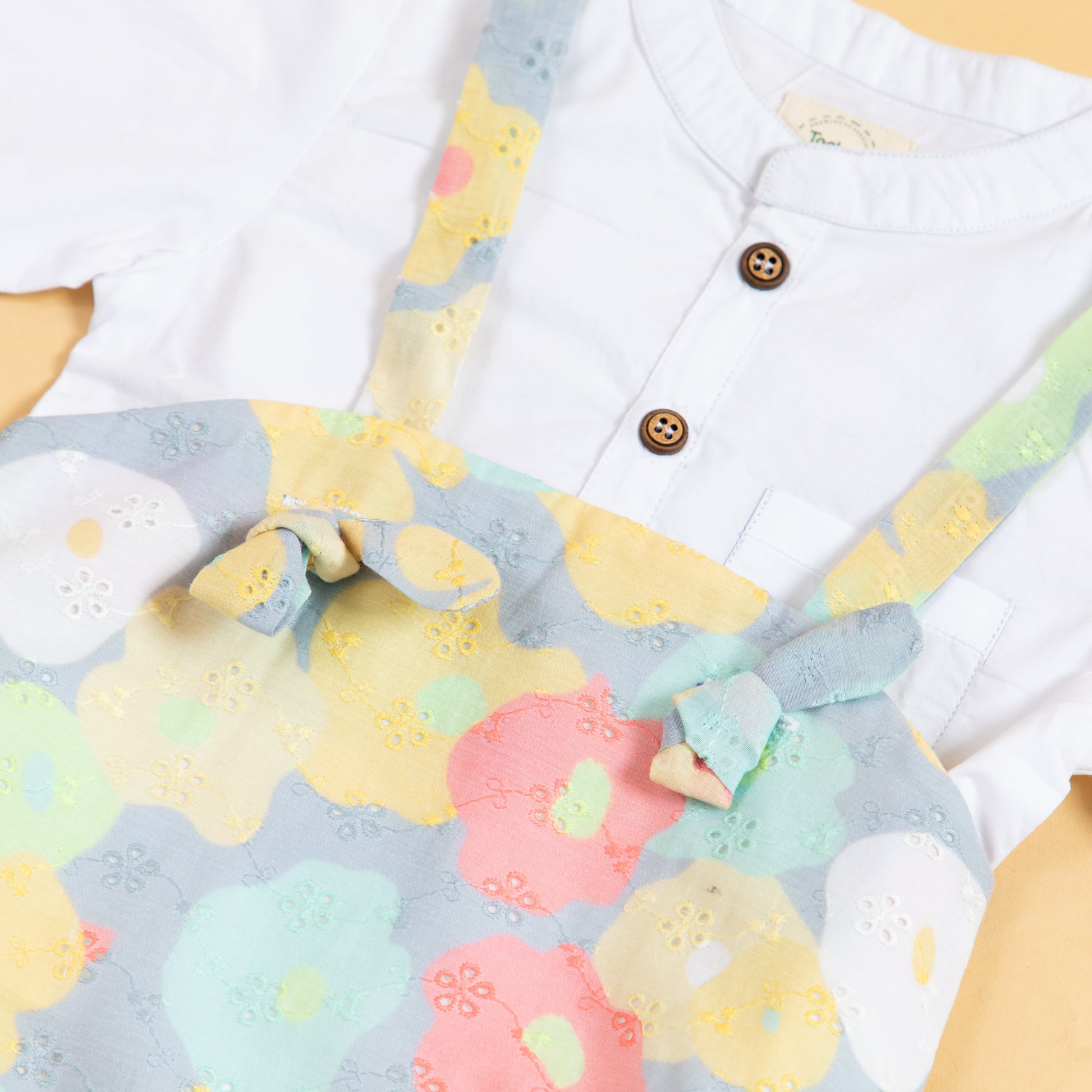 Colorful Stylera toddler romper set with shirt featuring floral patterns and button details
