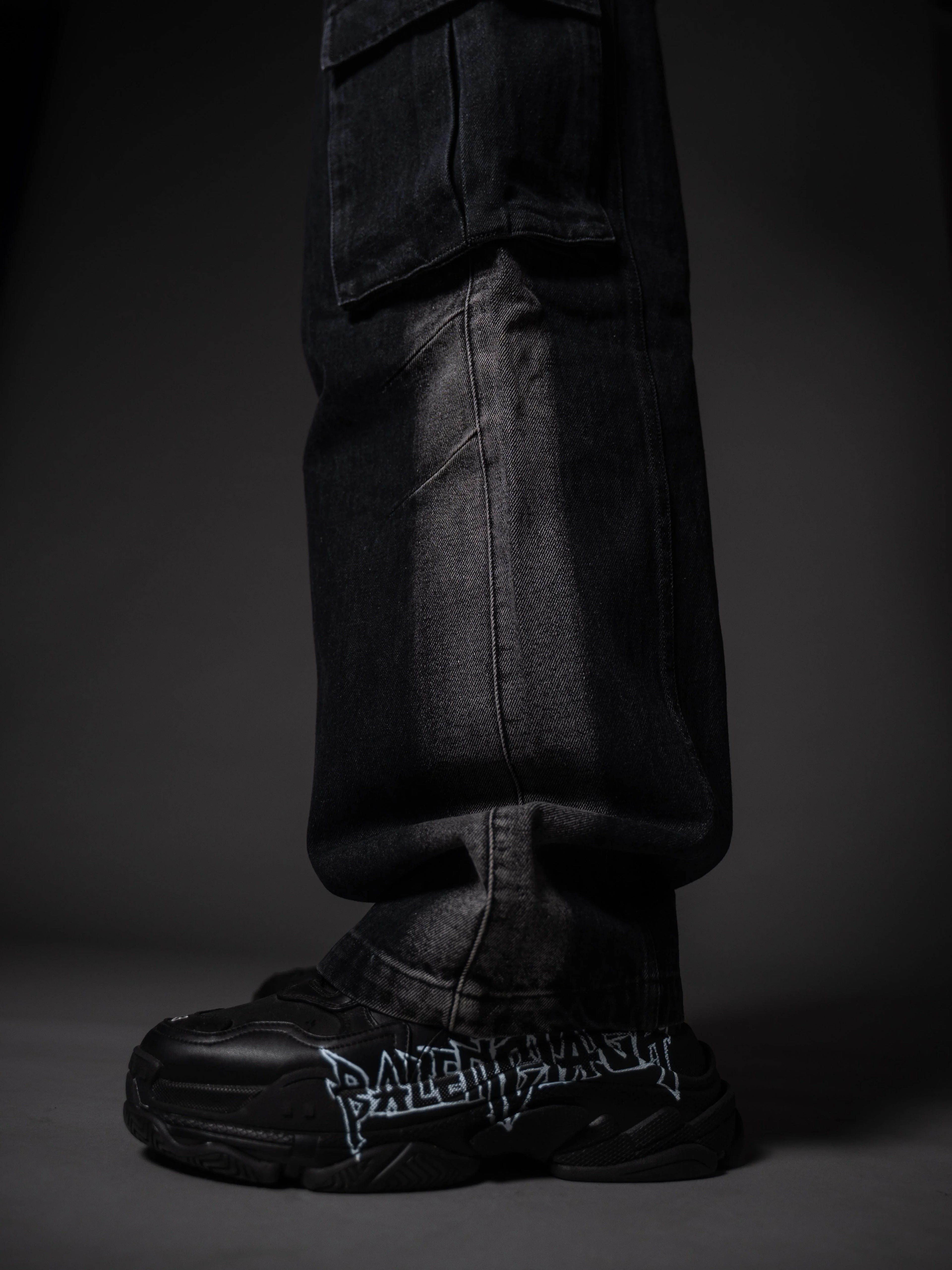Model posing in wide leg tough jeans streetwear outfit with chunky boots.