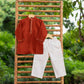 Traditional boys kurta set in rust color with white pants, perfect for festive occasions