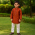 Traditional boys kurta set in rust color with white pants for festive occasions and celebrations
