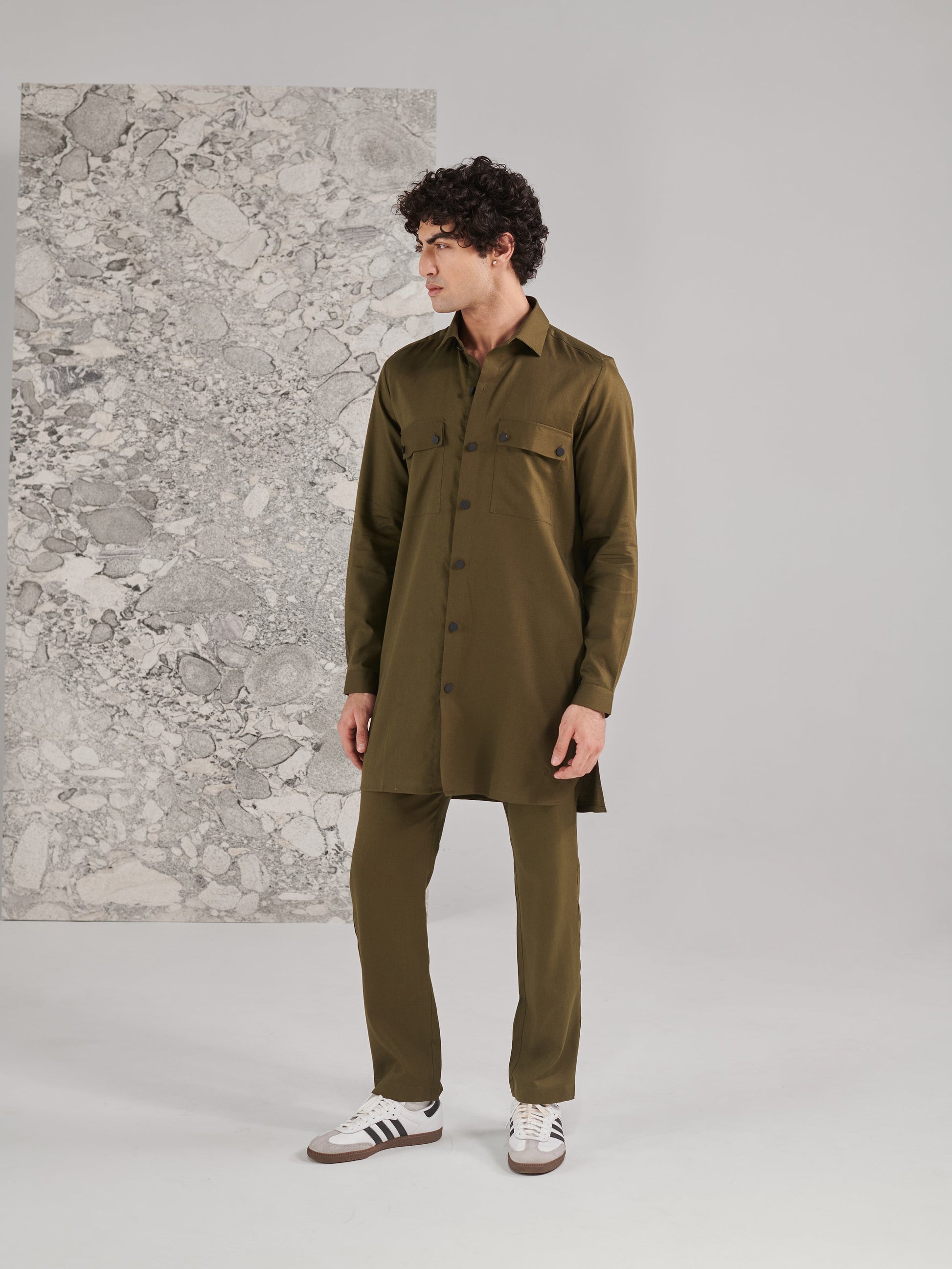 Stylish traditional green kurta pajama set for men, featuring long sleeves and front buttons