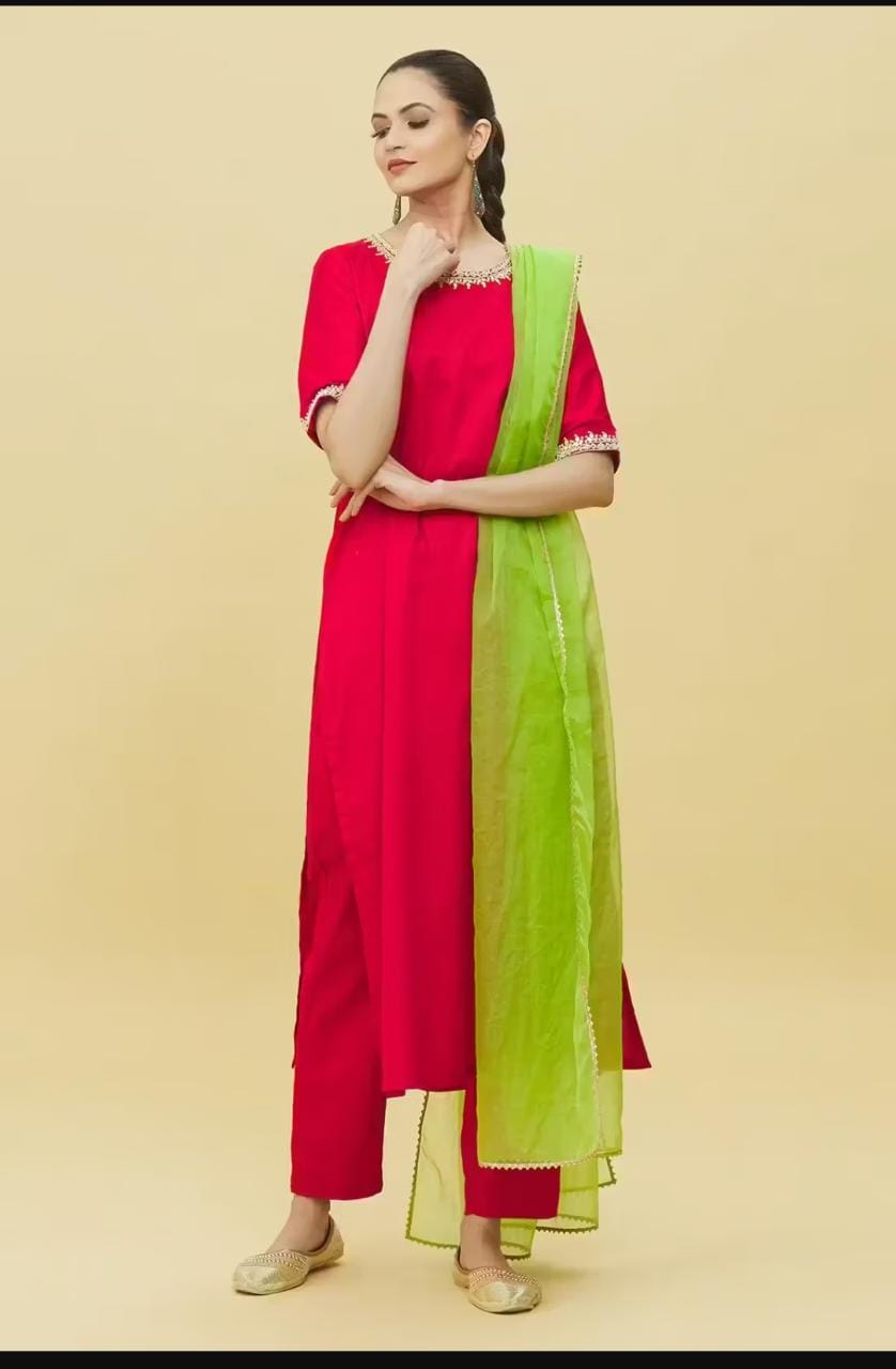 Model wearing Stylera traditional red suit with embroidery and green dupatta on beige background