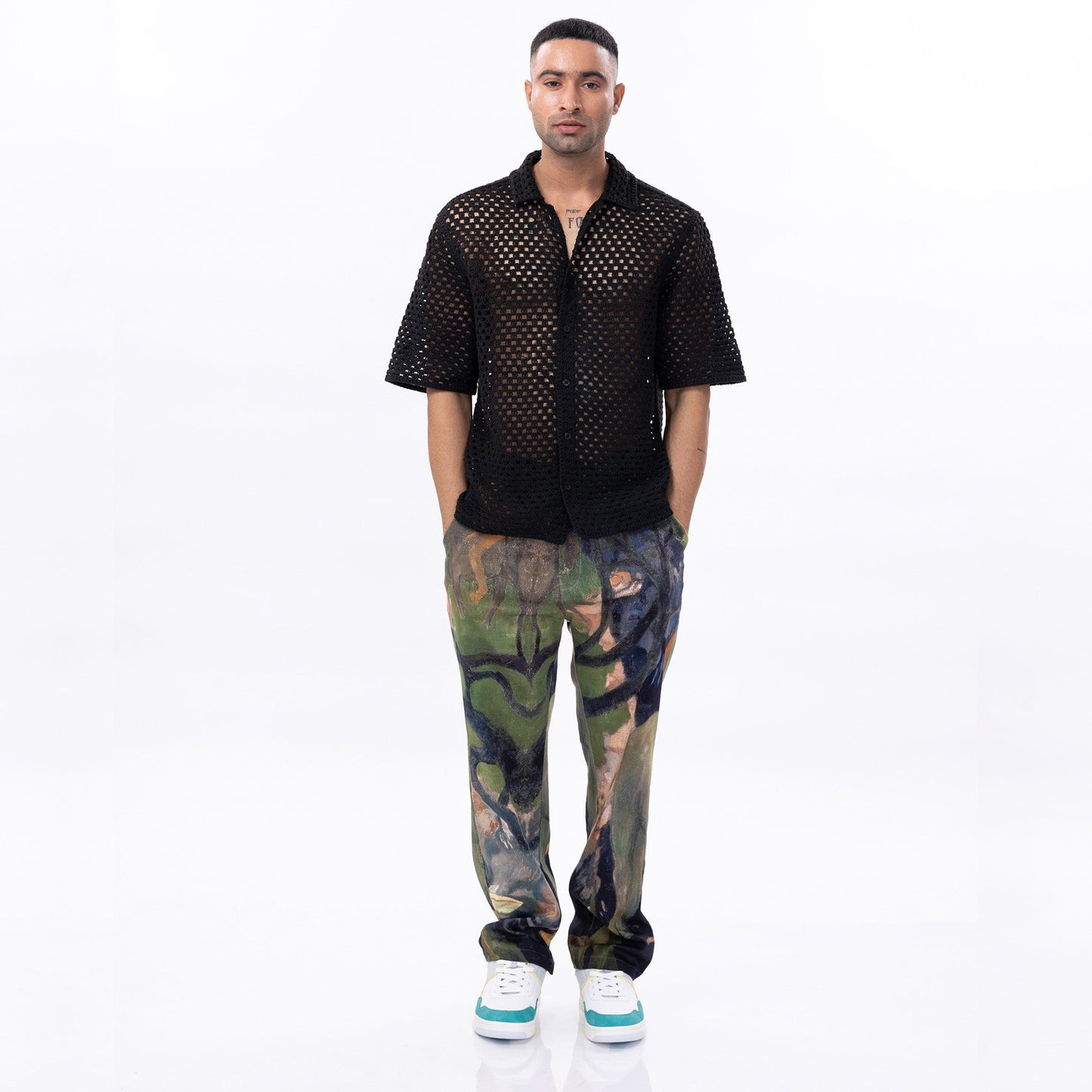 Stylera trendy abstract pattern pants in a colorful design paired with a black mesh shirt