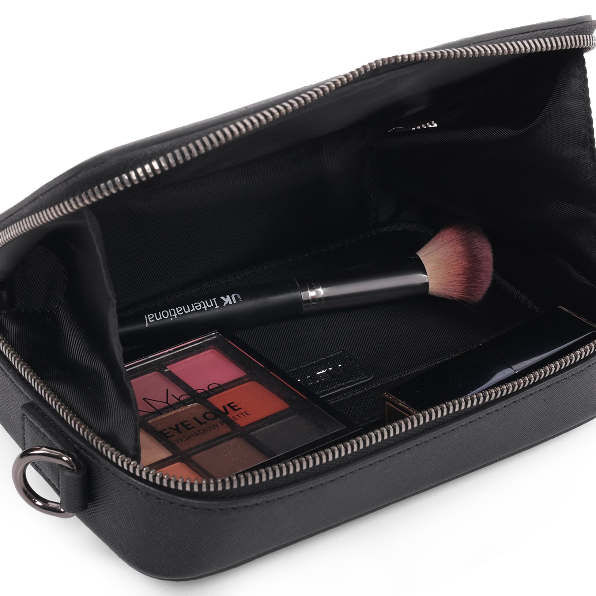 Stylera trendy accessory small black bag open showing makeup brush and eyeshadow palette for travel