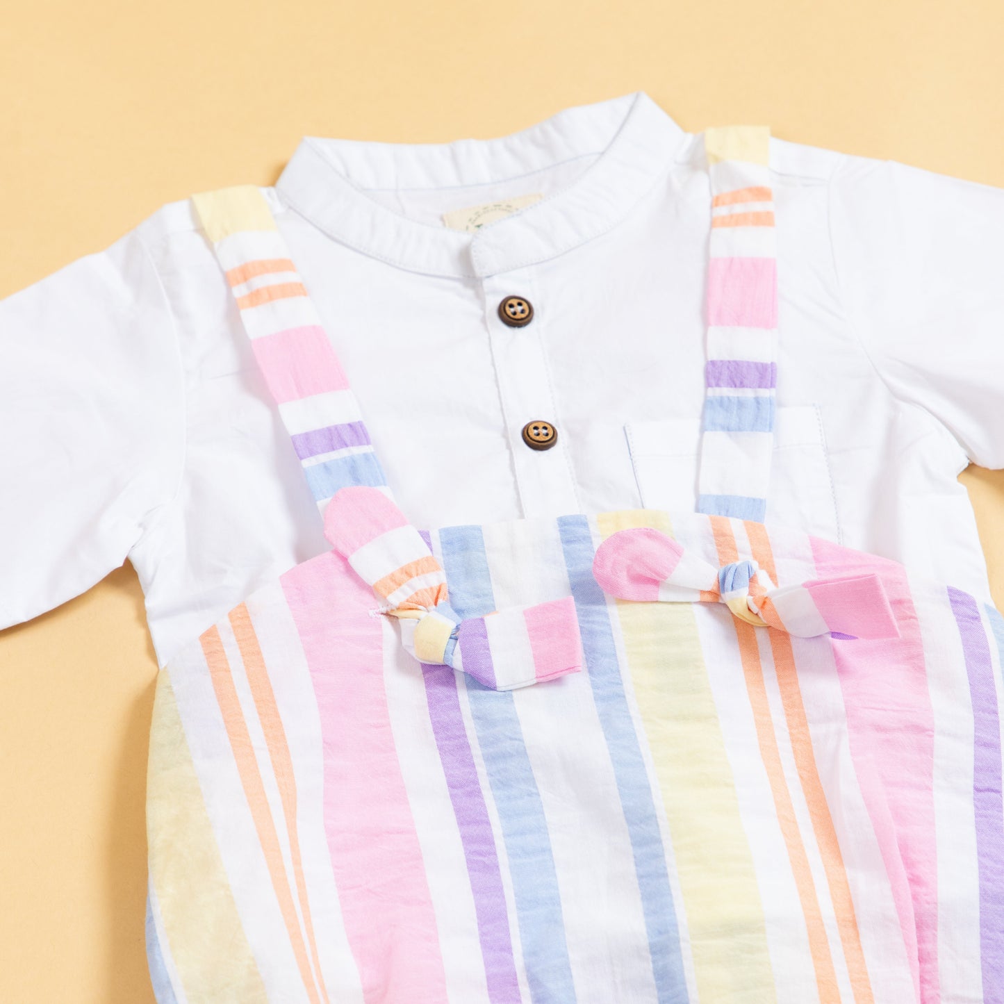 Stylish Stylera trendy baby clothes set featuring a white top and colorful striped overalls