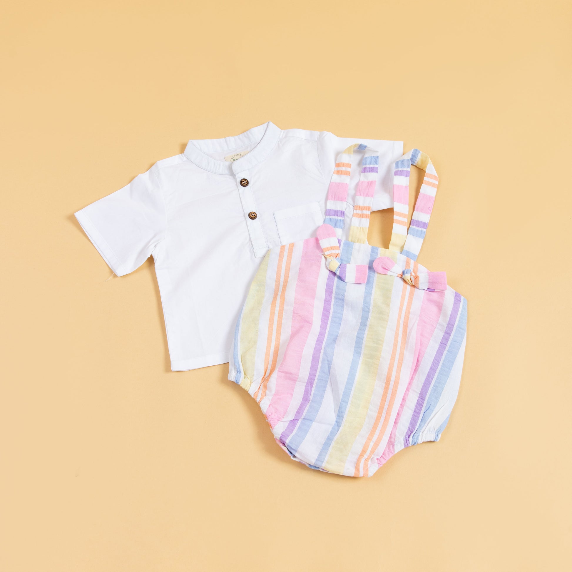 Trendy baby clothes set featuring a white shirt and colorful striped romper for stylish infants