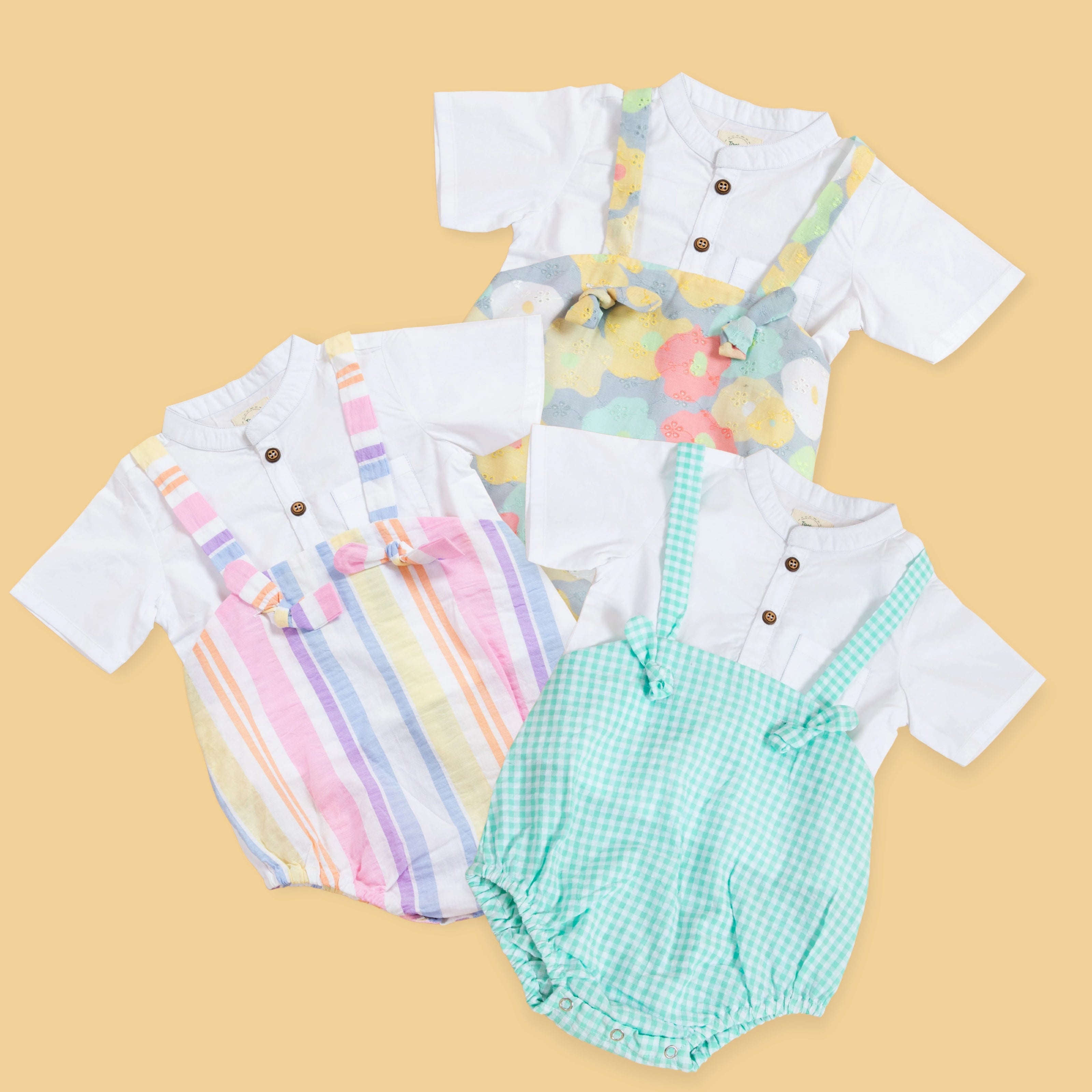 Three trendy baby clothing sets featuring colorful jumpers and white shirts for stylish infants