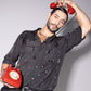 Stylish model wearing a trendy black men's fashion shirt with a vintage red phone