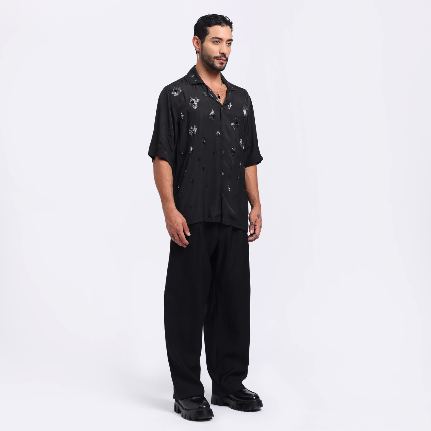 Trendy black men's fashion shirt with unique design details, styled for a modern look