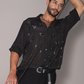 Trendy black men's fashion shirt from Stylera, featuring a stylish design and relaxed fit