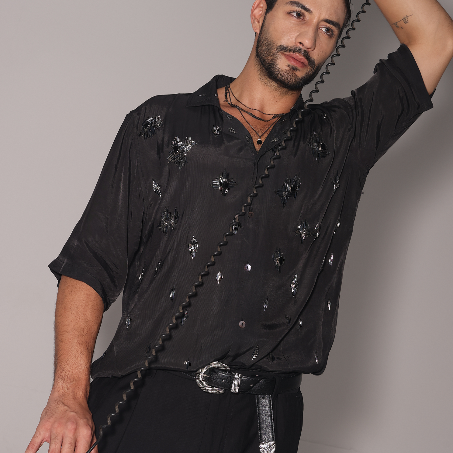 Trendy black men's fashion shirt from Stylera, featuring a stylish design and relaxed fit