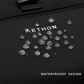 Stylera trendy black travel backpack close up showing waterproof textured fabric and water droplets on logo