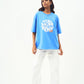 Model wearing Stylera trendy blue t-shirt for men and women oversized fit white graphic with white pants and sneakers
