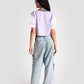 Back view of a woman wearing trendy casual tops for women in lavender and white paired with wide-leg jeans
