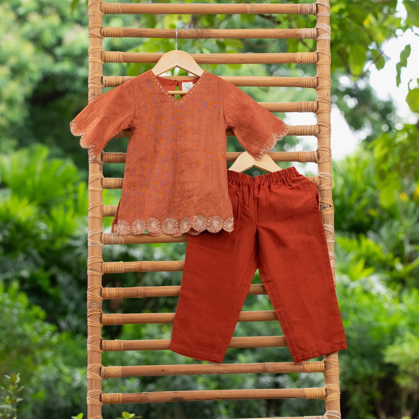 Trendy children's ethnic outfits featuring a rust-colored top and matching pants, perfect for festive occasions