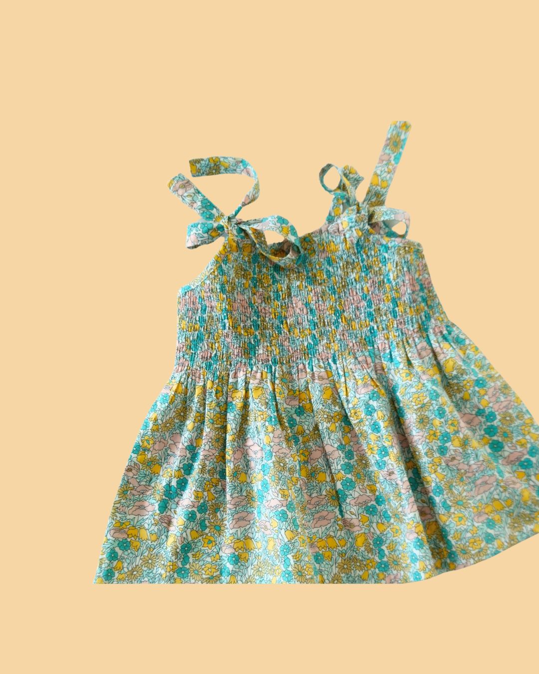 Trendy cyan casual dress with floral pattern and bow tie straps for a playful summer look