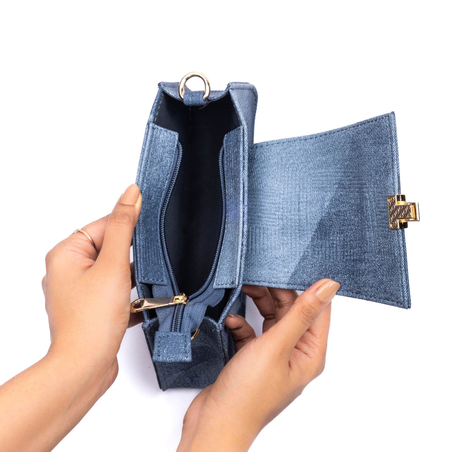 Trendy denim shoulder bag opened to show interior space and stylish design