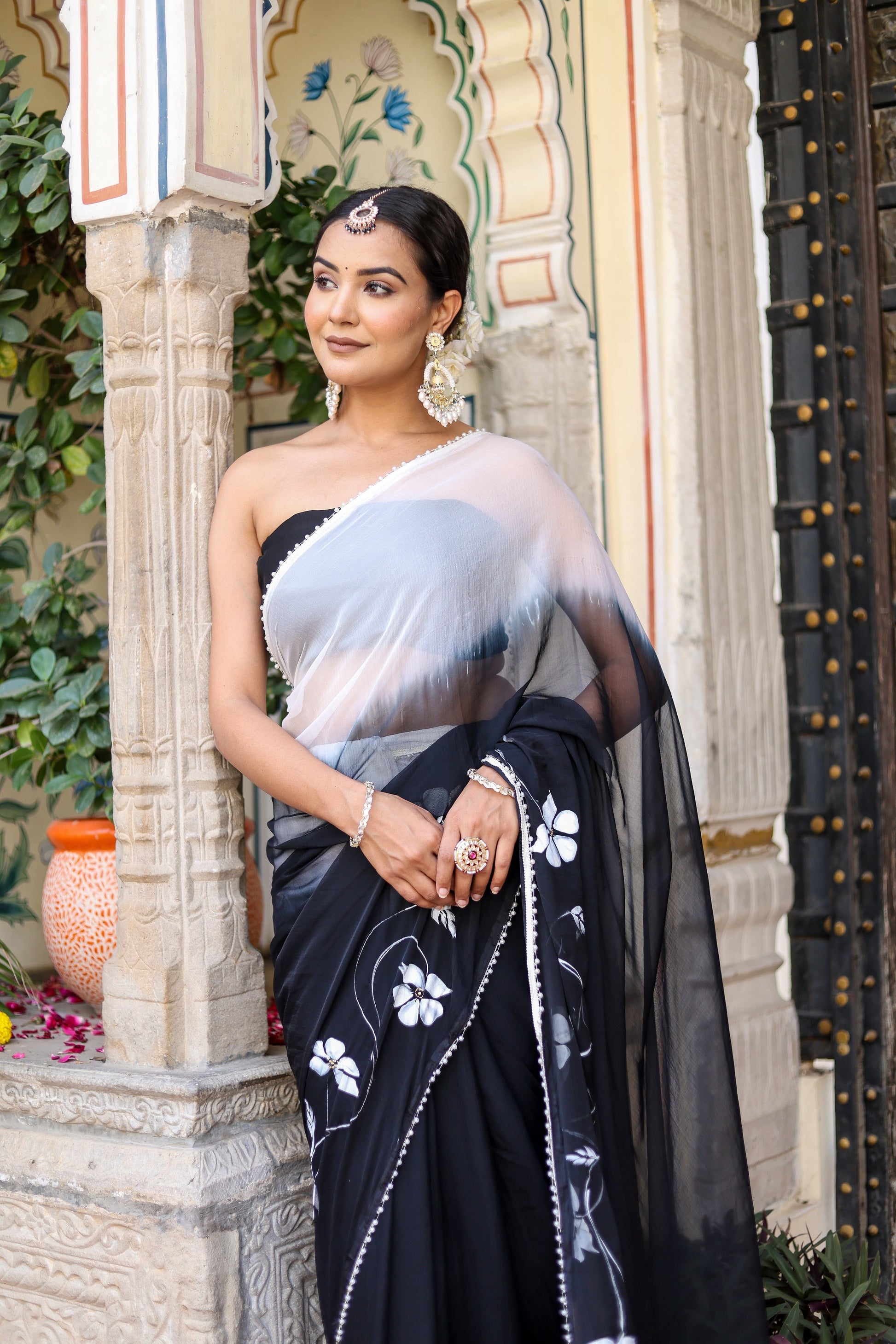 Trendy elegant party wear saree in black with floral embroidery and sheer pallu for festive occasions