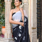 Trendy elegant party wear saree in black with floral prints, styled for a sophisticated look