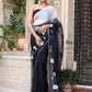 Trendy elegant party wear saree in black with floral embroidery, draped beautifully for festive occasions