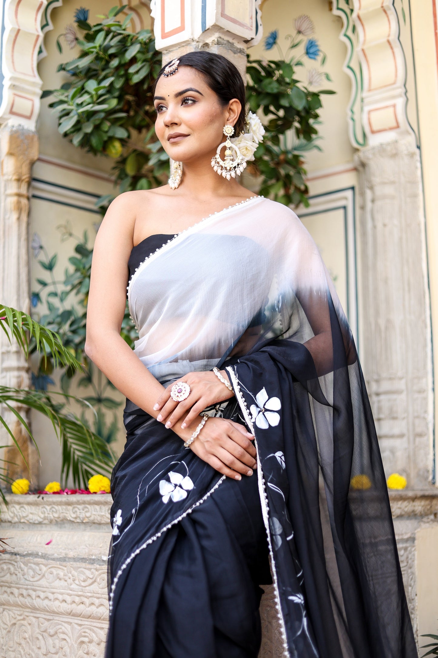 Stylera trendy elegant party wear saree in black with floral prints and stylish drape