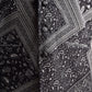 Close-up of a trendy ethnic bandi jacket featuring intricate paisley patterns in black and white