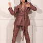 Model wearing a trendy ethnic blazer pant set in brown with a stylish belt and patterned design
