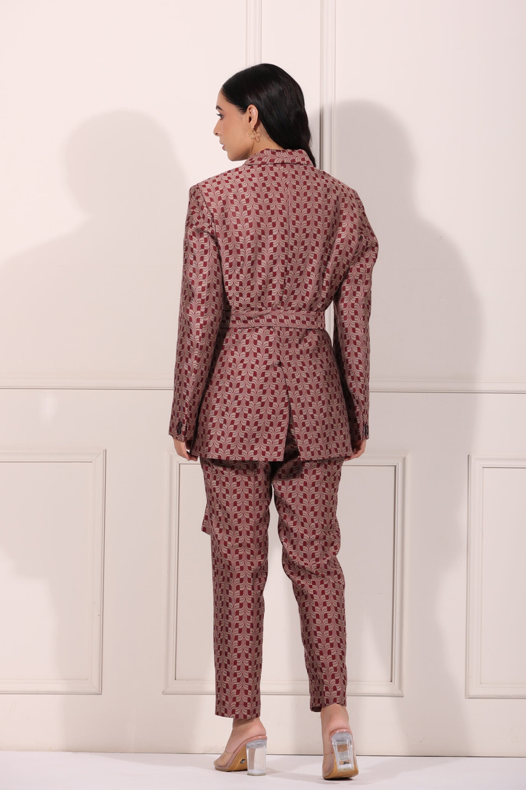 Back view of a trendy ethnic blazer pant set in a stylish pattern with a tailored fit