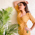 Model wearing a mustard yellow wrap top, showcasing trendy ethnic wear for summer with stylish accessories