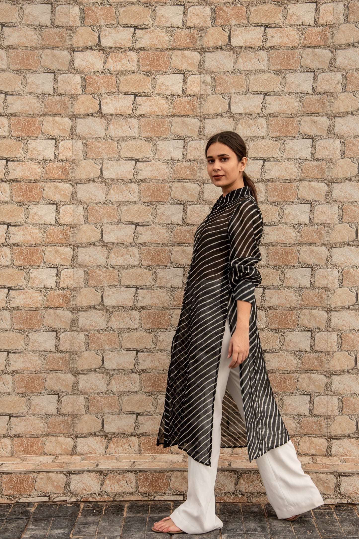 Elegant black and white striped kurta showcasing trendy ethnic wear for women in a stylish pose