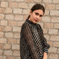 Stylish Stylera's trendy ethnic wear for women with black and white stripes against a brick wall