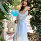 Stylera trendy evening maxi dress featuring sheer sleeves and a thigh-high slit in a garden setting