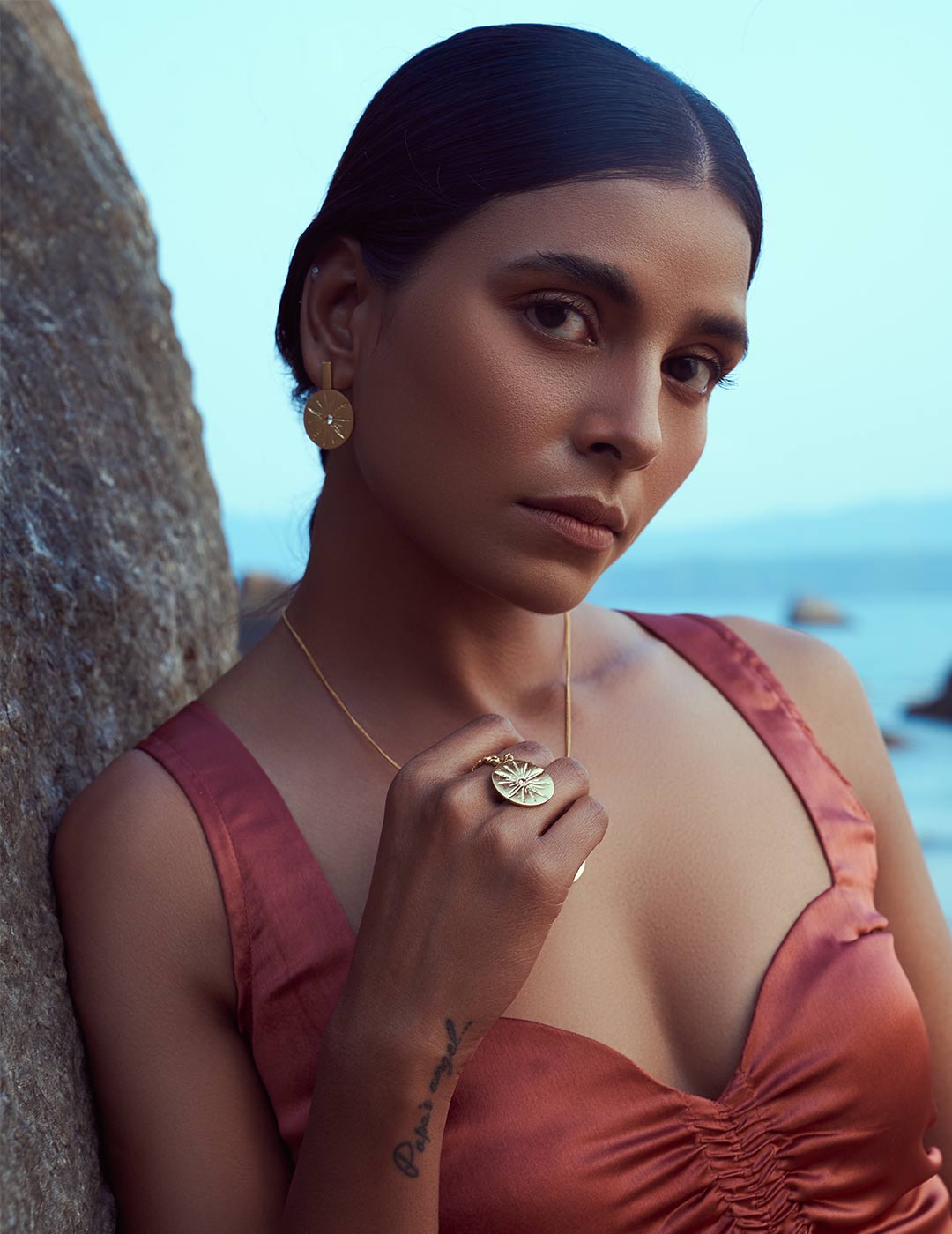Stylera gold statement ring on model hand with matching pendant and earrings trendy gold fashion accessories