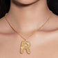 Stylera trendy gold R pendant necklace on model with textured beaded R and small pearl accents