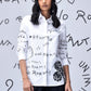Stylera white button up shirt with black handwritten graphics on model trendy graphic shirts for women