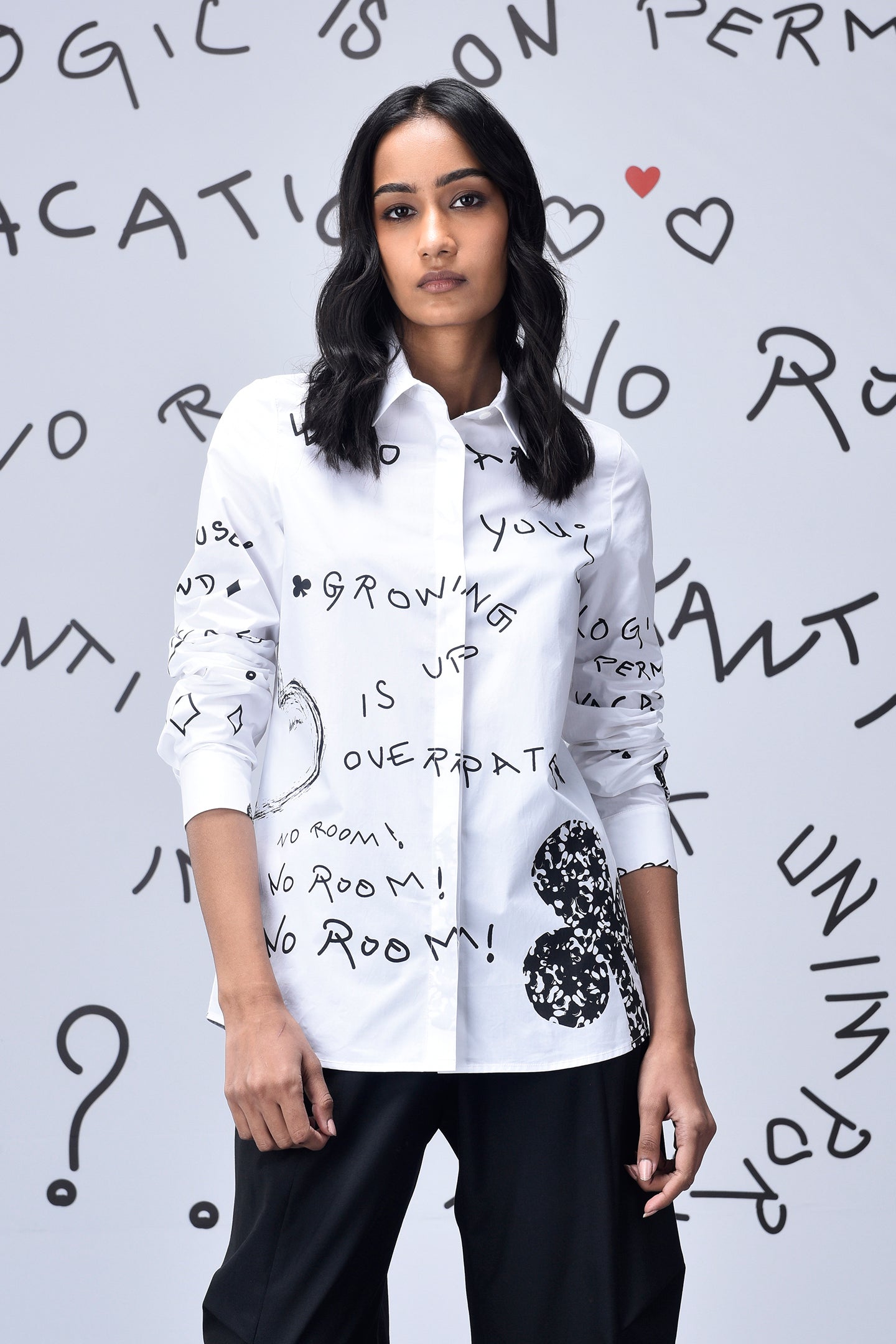 Stylera white button up shirt with black handwritten graphics on model trendy graphic shirts for women