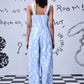 Back view of Stylera trendy ikat print jumpsuit in light blue and white with wide straps