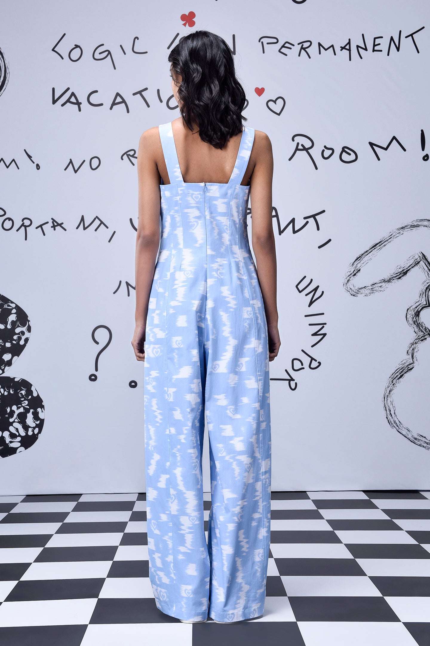 Back view of Stylera trendy ikat print jumpsuit in light blue and white with wide straps