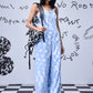 Stylera trendy ikat print jumpsuit in light blue worn with black and white backpack