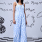Woman wearing trendy ikat print jumpsuit dungaree by Stylera in light blue and white pattern