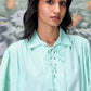 Stylera mint green collared shirt with lace up front and billowy sleeves trendy loose fit women's top on model