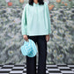 Stylera mint green blouse with lace up neck holding striped hat trendy loose fit women's top