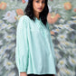 Stylera mint green blouse modeled as a trendy loose fit women's top with long sleeves