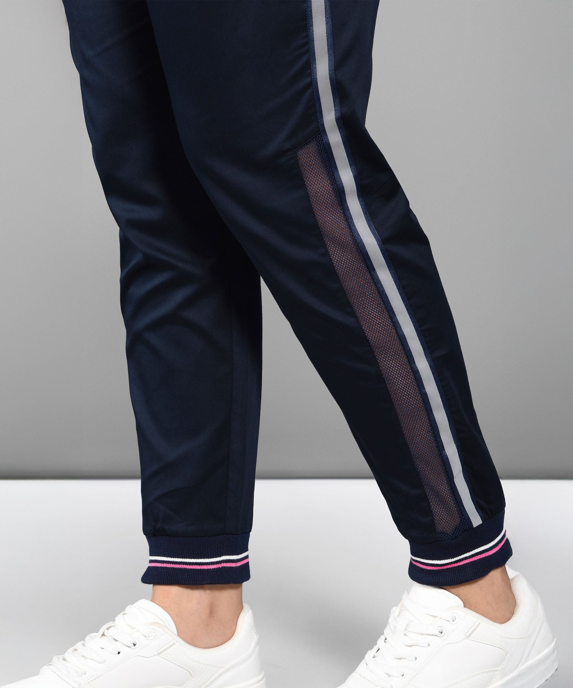 Navy athletic pants with mesh details and stripes, perfect for trendy matching outfits for women