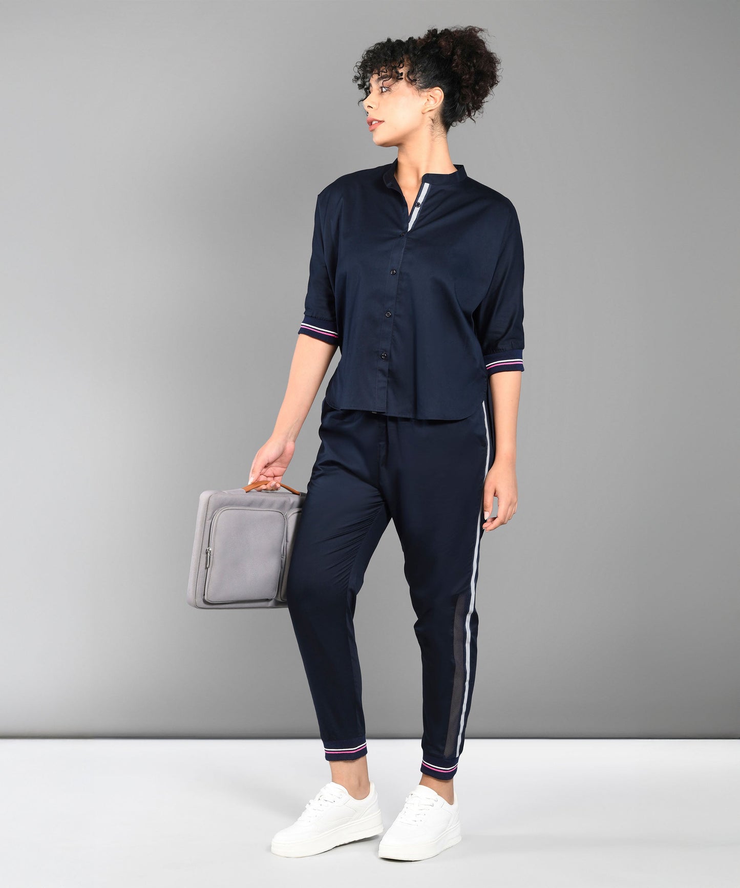 Stylish navy trendy matching outfits for women featuring a short-sleeve top and tapered pants