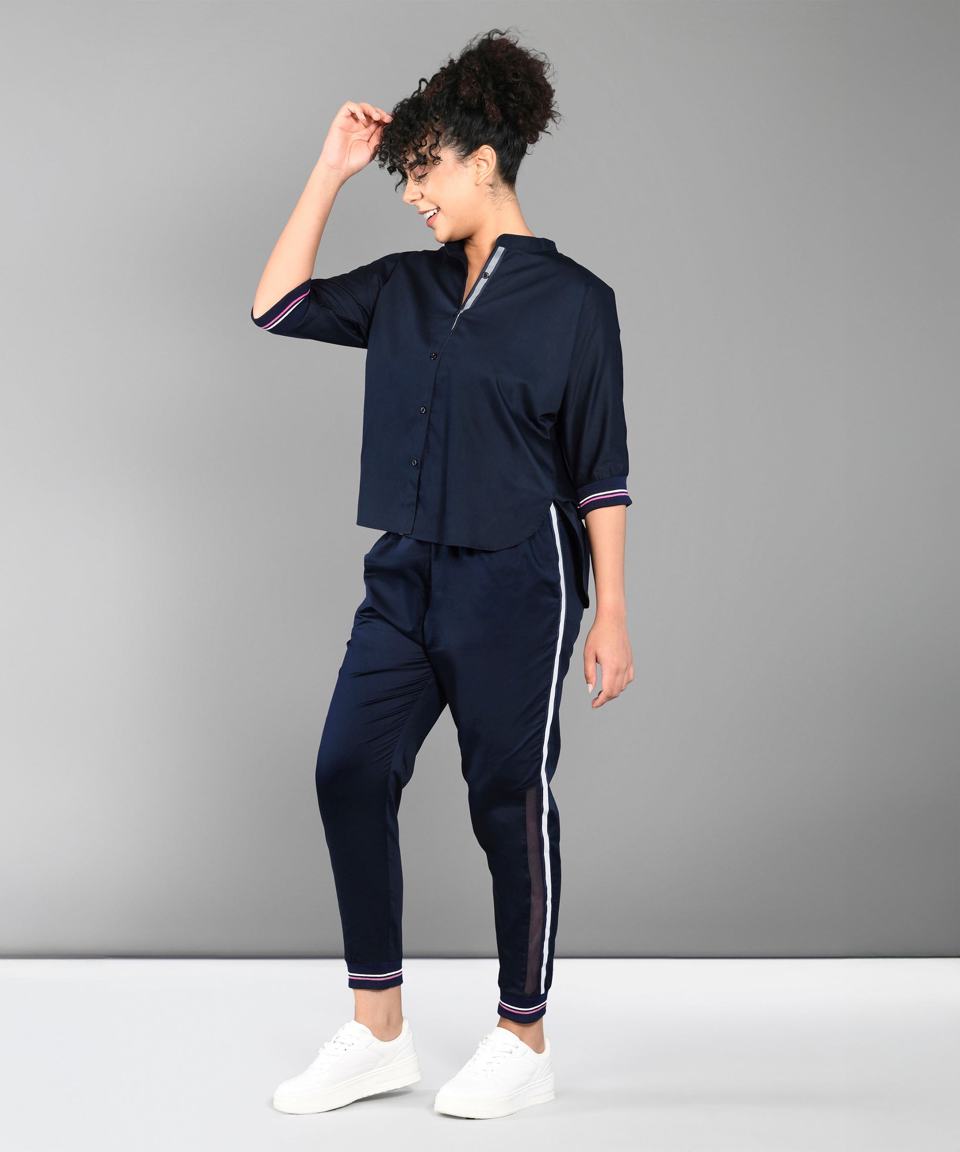 Trendy matching outfits for women featuring a navy crop shirt and jogger pants with stripes